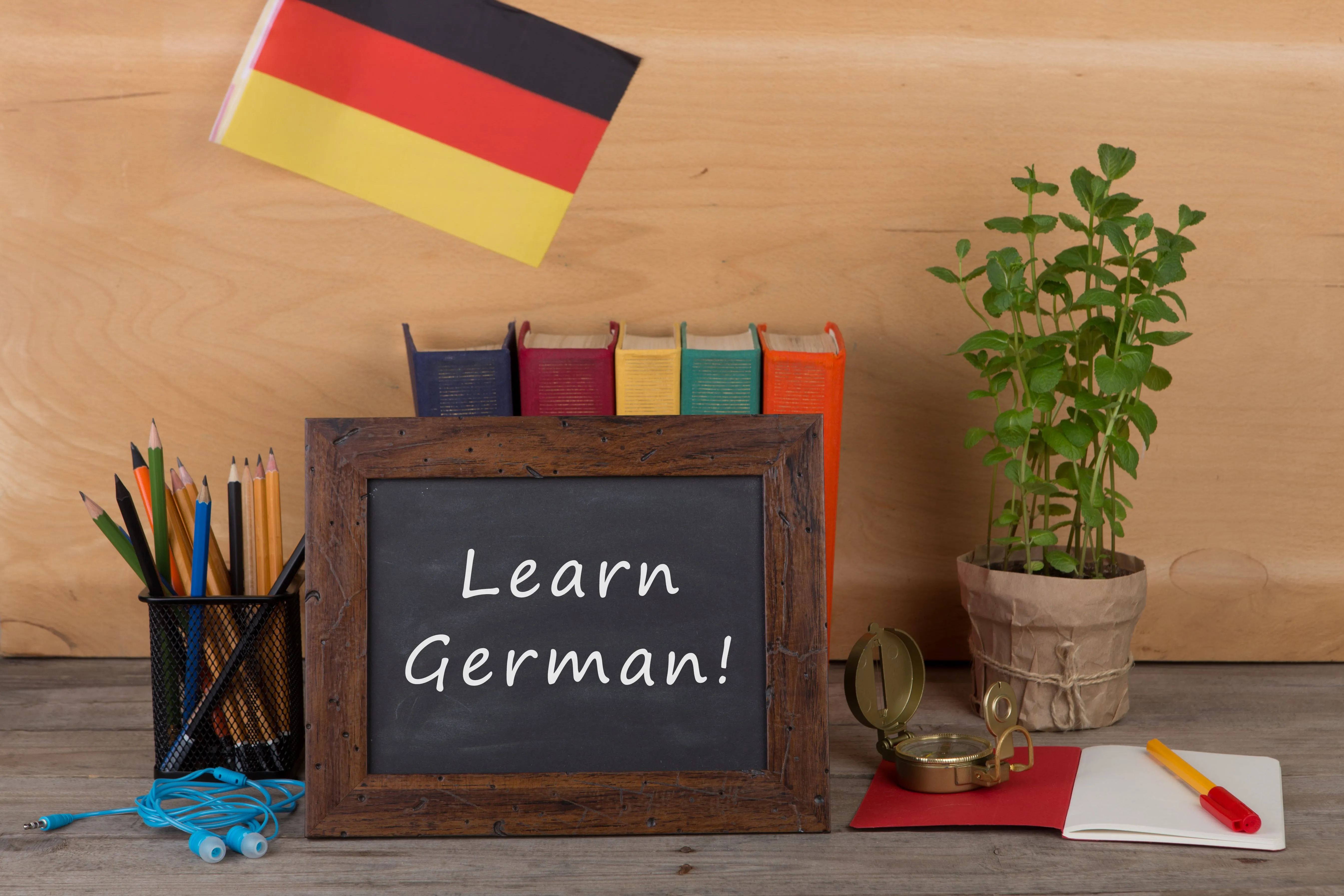 learning-languages-concept-blackboard-with-text-learn-german-flag-germany-books-chancellery-min